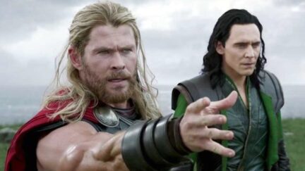 Chris Hemsworth as Thor reaches for his hammer next to Tom Hiddleston as Loki in 'Thor: Ragnarok'