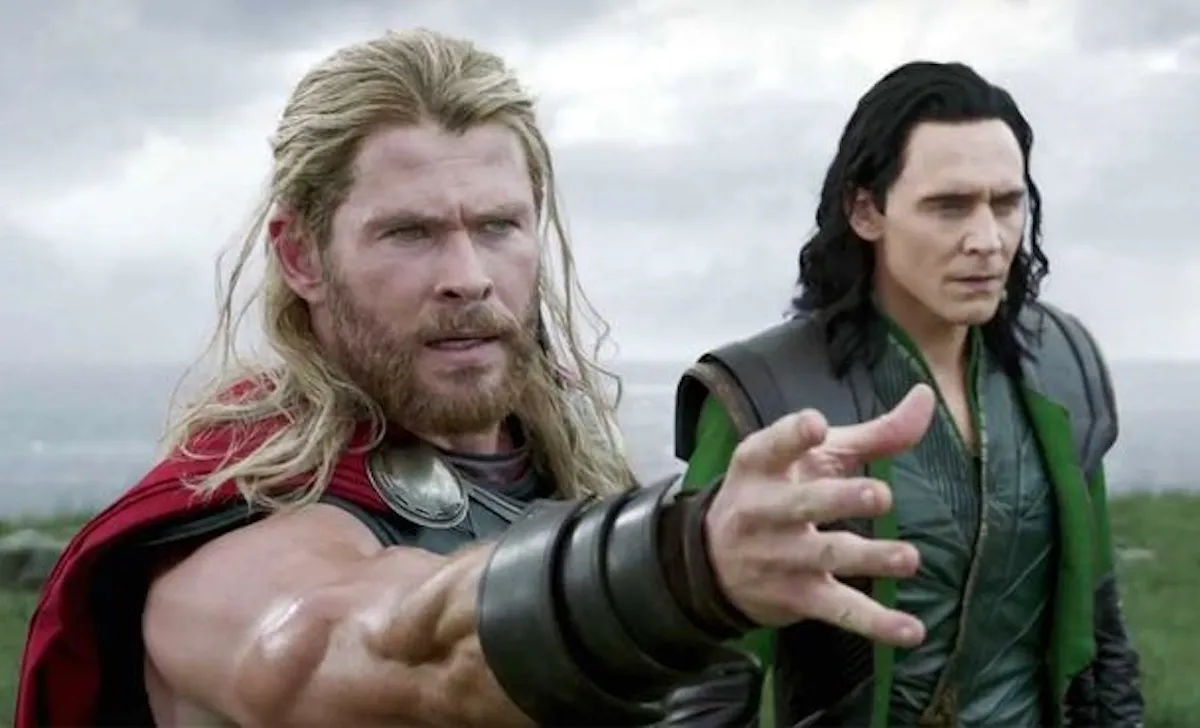 Chris Hemsworth as Thor reaches for his hammer next to Tom Hiddleston as Loki in 'Thor: Ragnarok'