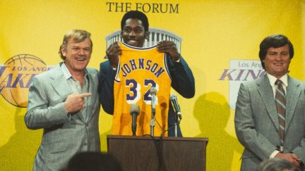 Dr Jerry Buss and Magic Johnson hold up an LA Lakers jersey