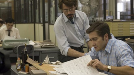 Robert Downey Jr. and Jake Gyllenhaal looking at papers in Zodiac