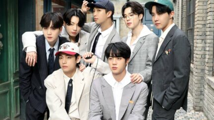 A picture of the seven members of BTS during the photoshoot for the concept photos of their album BE