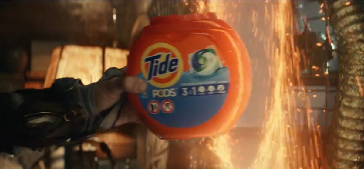 Wong pulls a bottle of Tide detergent out of a portal.