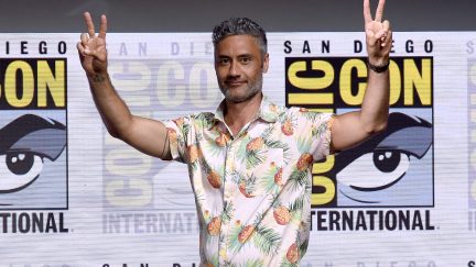 Taika holding up peace signs at comic con