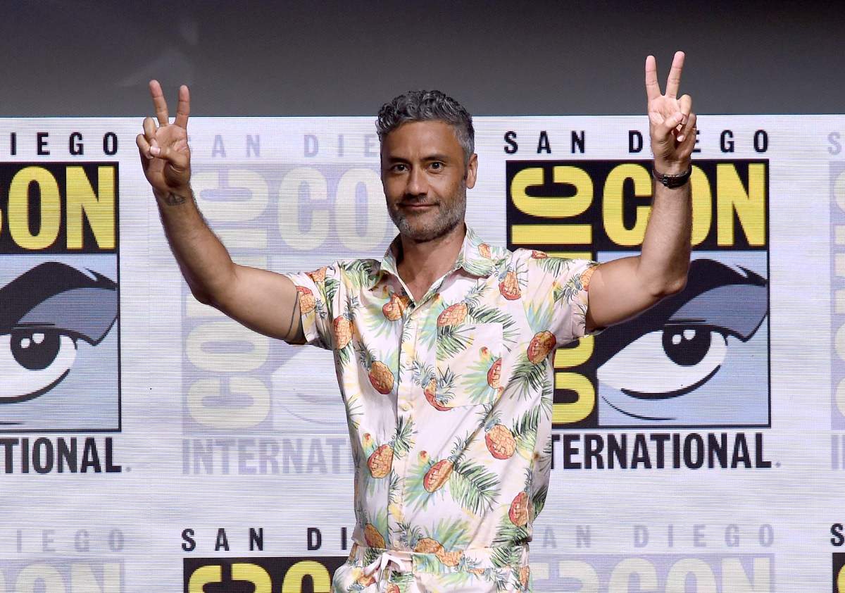 Taika holding up peace signs at comic con