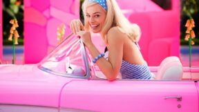 Margot Robbie as Barbie in a pink car