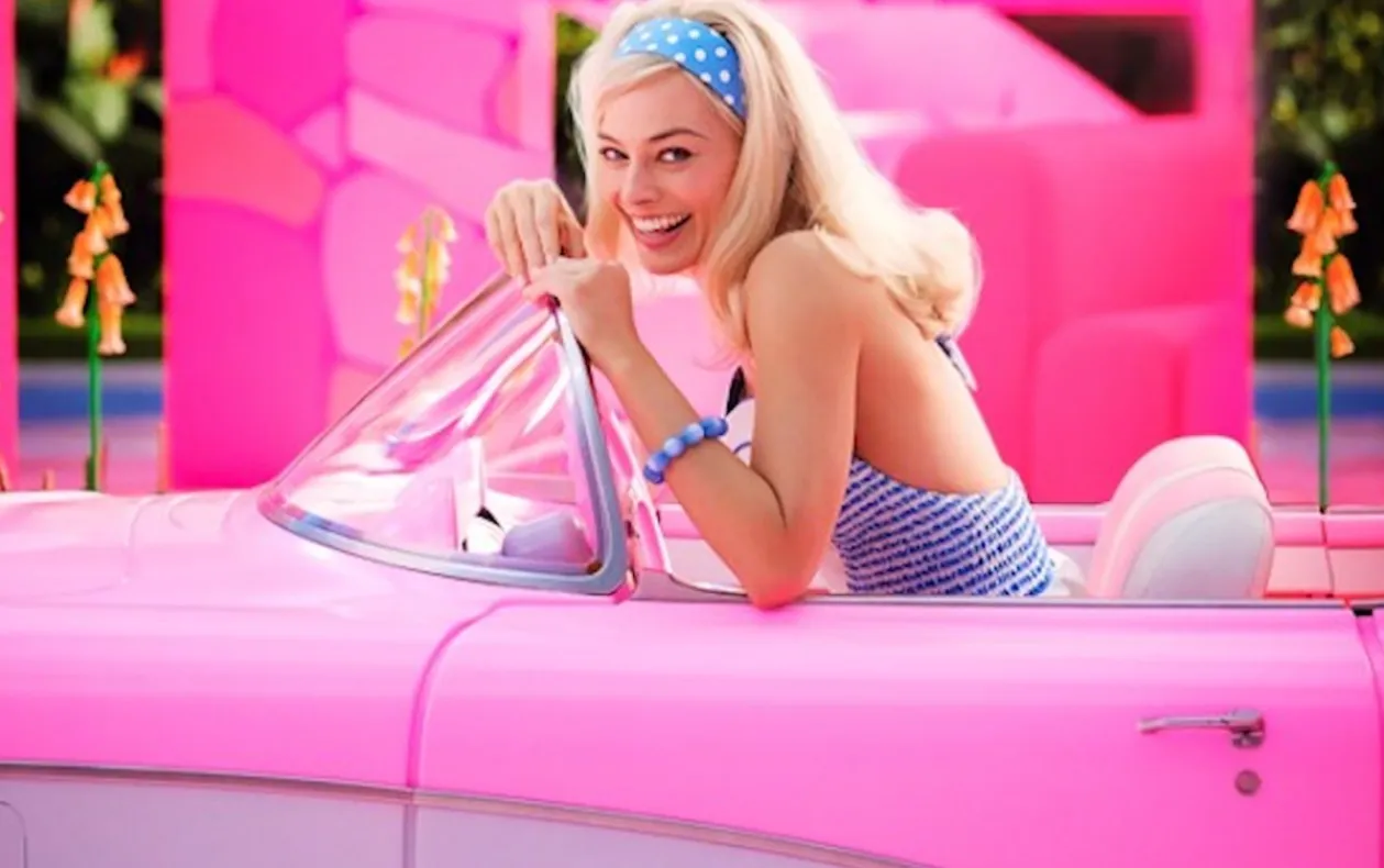 Margot Robbie as Barbie in a pink car
