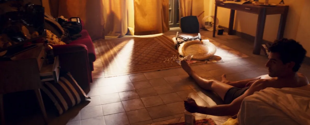 Oscar Isaac sitting shirtless on the floor in Moon Knight