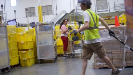 Employees work at an Amazon Fulfillment Center
