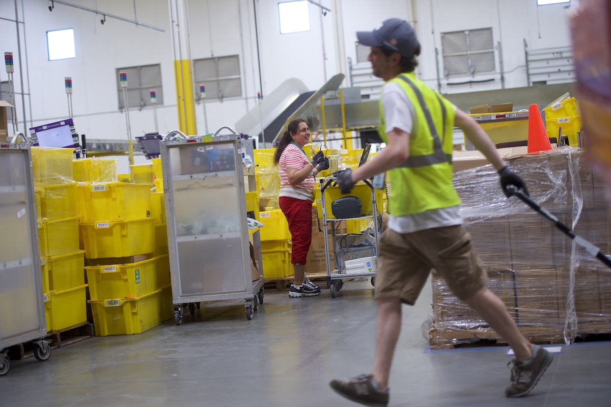 Employees work at an Amazon Fulfillment Center