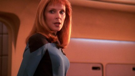 Gates McFadden as Dr Beverly Crusher, standing on the bridge of the Enterprise.