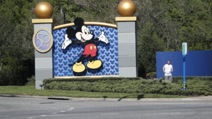 A view of the entrance of Walt Disney World featuring a giant Mickey Mouse image with his arms outstretched