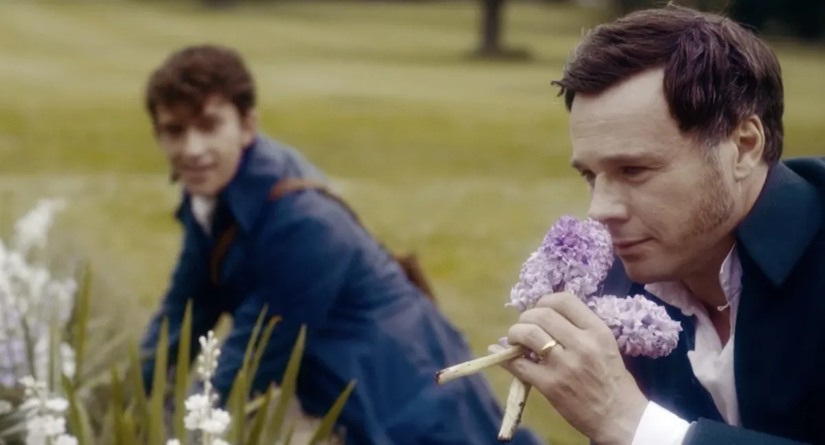 Anthony Bridgerton and Edmund Bridgerton picking flowers in a Bridgerton season 2 flashback
