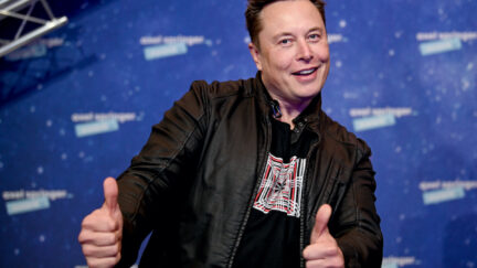 Elon Musk mugs and gives two thumbs up