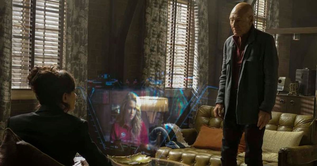 the watcher sits while Picard stands and stares at a hologram