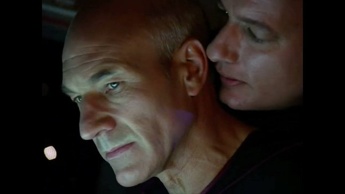 Q whispering softly in Picard's ear