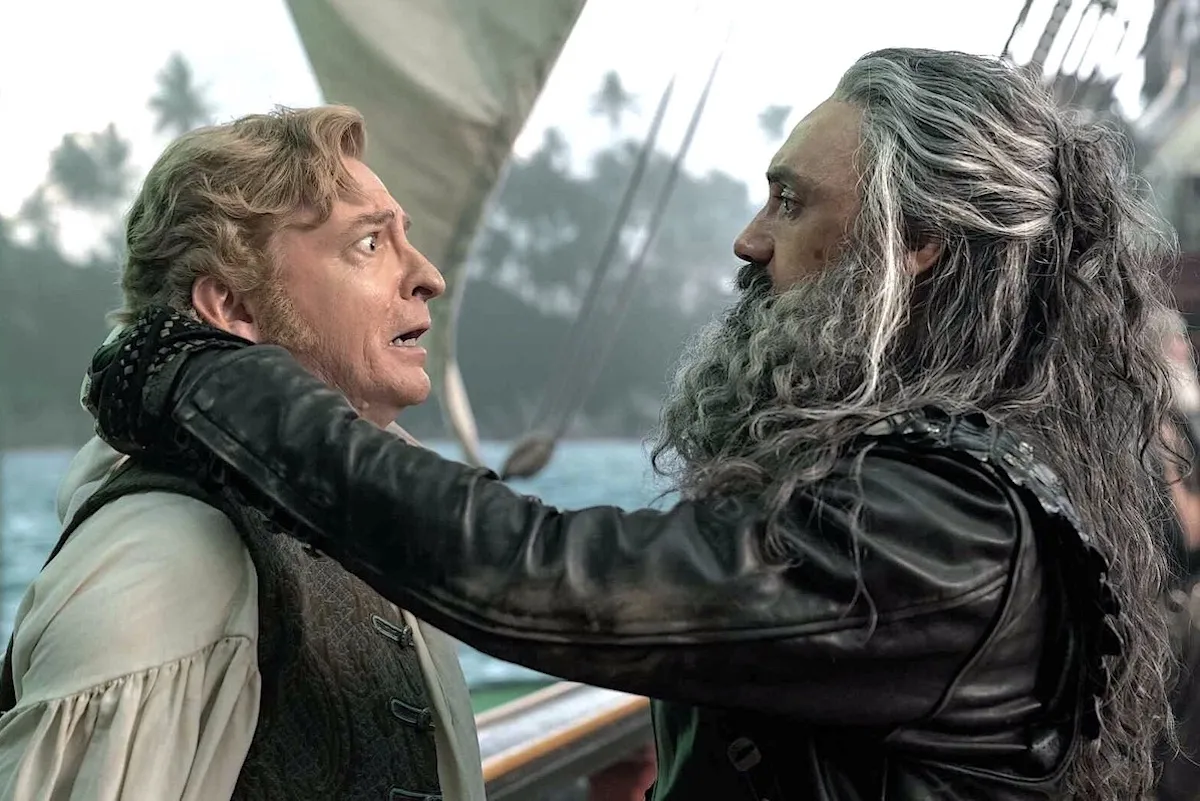 Taika Waititi as Blackbeard takes of Rhys Darby as Stede Bonnet's blindfold on 'Our Flag Means Death'