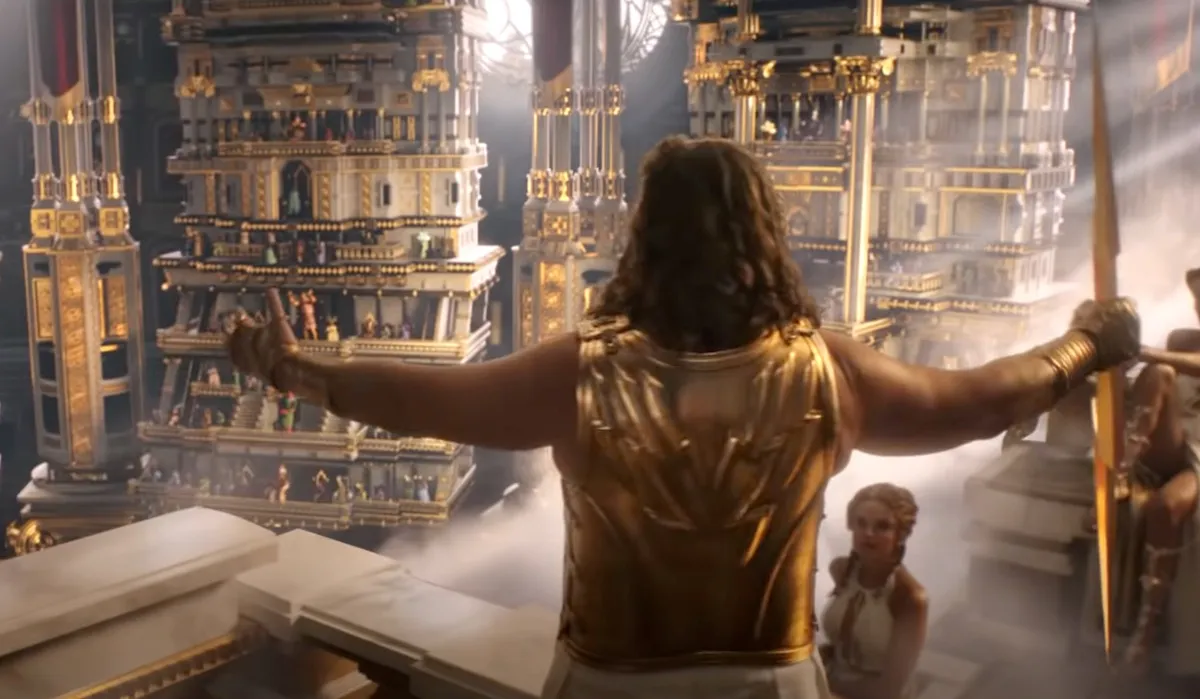 Russell Crowe as Zeus raises his hands in Thor: Love and Thunder