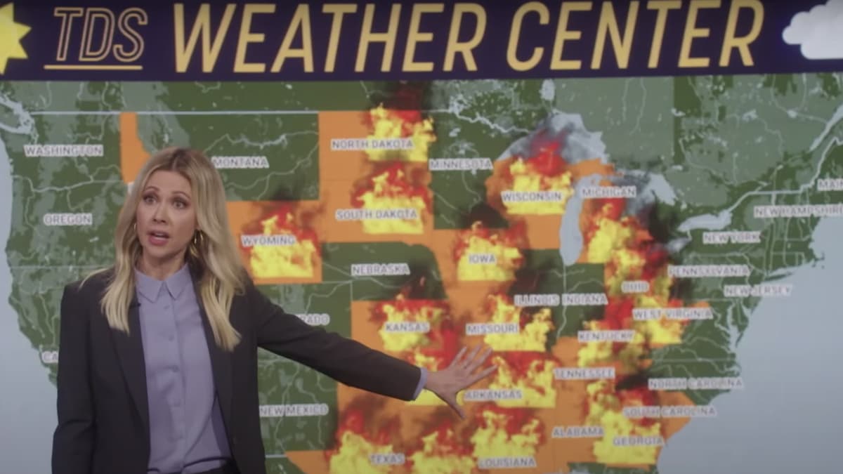 Desi Lydic illustrating how everything is on fire during The Daily Show