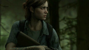 Ellie standing wary with a gun in the woods