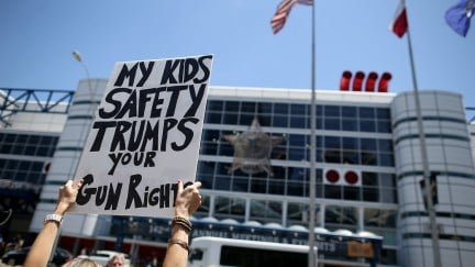 A sign says my kids safety trumps your gun rights at a protest