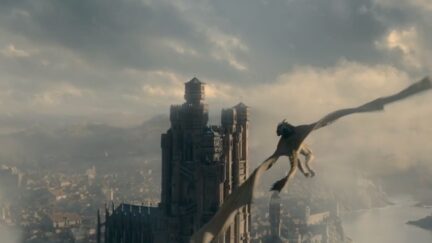 A screenshot from the trailer for House of the Dragon, Game of Thrones' prequel series, featuring a Targaryen dragonknight on top of a dragon flying over King's Landing