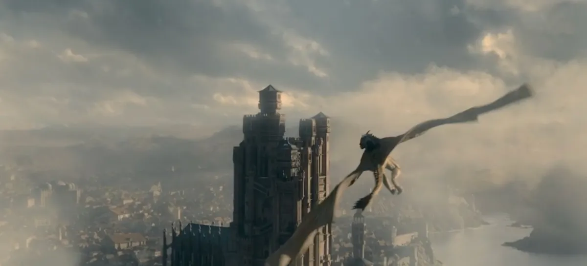 A screenshot from the trailer for House of the Dragon, Game of Thrones' prequel series, featuring a Targaryen dragonknight on top of a dragon flying over King's Landing