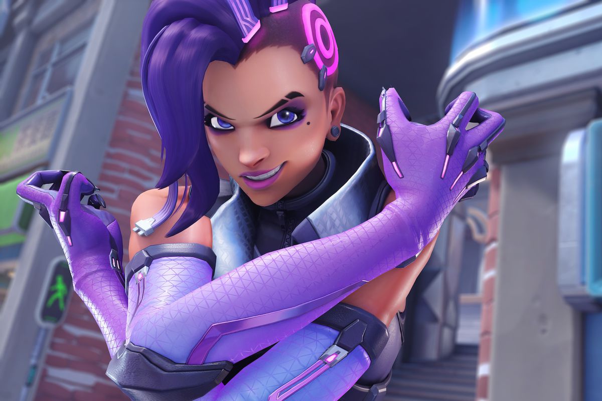 Sombra poses menacingly with crossed arms and a grin.