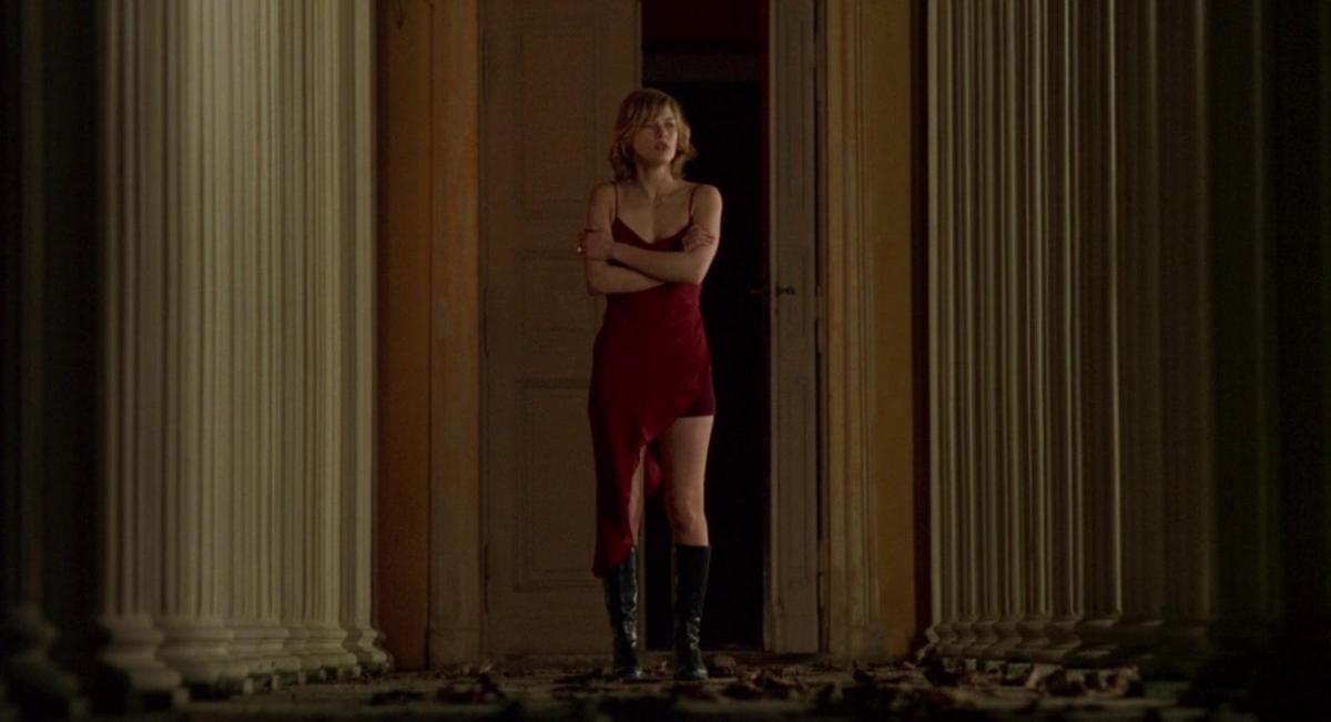Alice standing in a red dress in Resident Evil