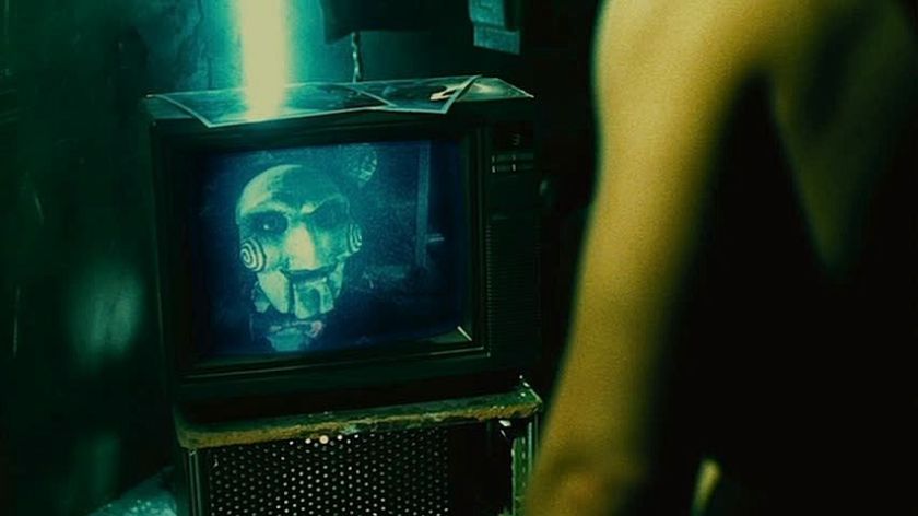 Billy the puppet on a TV in Saw II