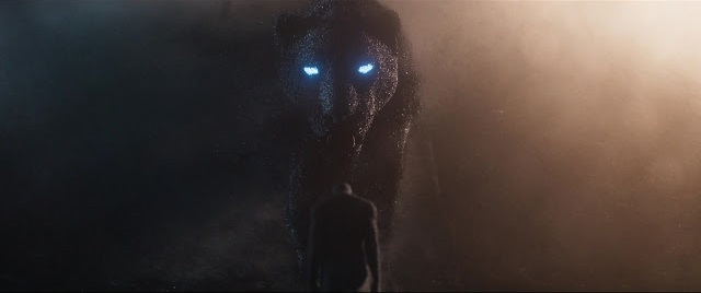 Big black cat with glowing eyes in Black Panther (2018.) Image: Marvel Entertainment.