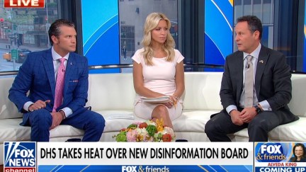 The three hosts of fox & friends sit and talk at each other in their studio.