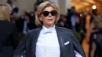 Christine Baranksi looks fierce on the Met Gala red carpet in sunglasses and a caped tuxedo outfit.