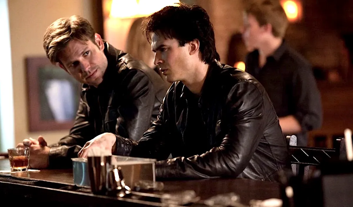 Matt Davis as Alaric Saltzman and Iam Somerhalder as Damon Salvatore drink at the bar in The Vampire Diaries