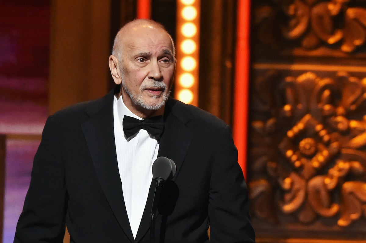 Frank Langella wears a tuxedo while standing at a podium on stage.