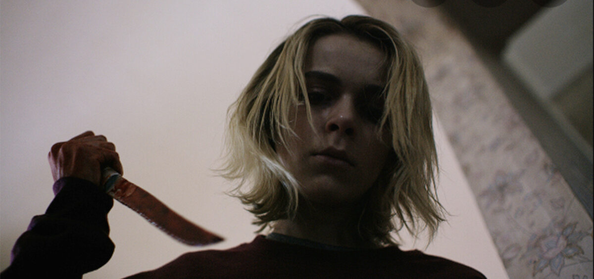 Katherine holding a bloody knife