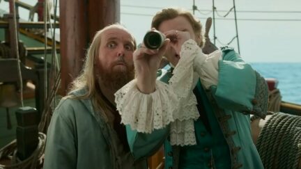 Ewen Bremner as Nathaniel Buttons looking out next to Rhys Darby as Stede Bonnet. Image: HBO Max.