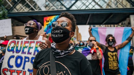 Black demonstrators march in the streets during a Pride rally