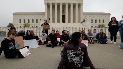 A group of pro-choice protesters sit gathered outside the US Supreme Court