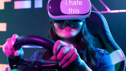 A woman wears a VR headset and holds a steering wheel, grinning. Text overlay on the headset reads 