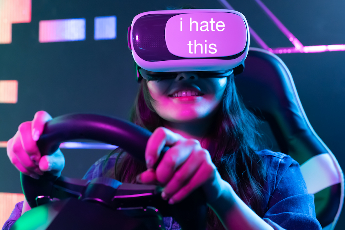 A woman wears a VR headset and holds a steering wheel, grinning. Text overlay on the headset reads "i hate this"