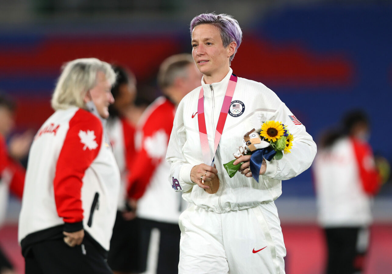 YOKOHAMA, JAPAN - AUGUST 06: Bronze medalist Megan Rapinoe of Team United States reacts with their bronze medal during the Women's Football Competition Medal Ceremony on day fourteen of the Tokyo 2020 Olympic Games at International Stadium Yokohama on August 06, 2021 in Yokohama, Kanagawa, Japan. (Photo by Naomi Baker/Getty Images)