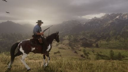 A man rides a horse while carrying a gun in the game 'Red Dead Redemption 2'