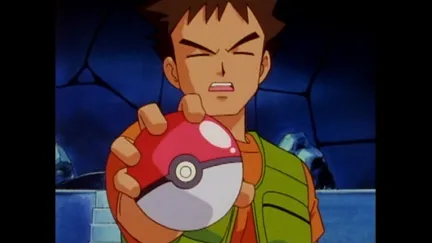Brock holds a Pokéball towards the screen in Pokémon anime.