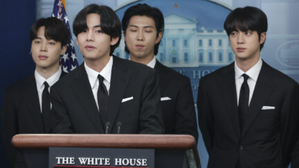 Members of the K-pop band BTS stand behind the podium in the White House briefing room