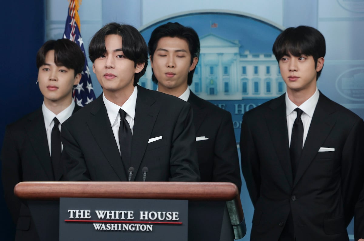 Members of the K-pop band BTS stand behind the podium in the White House briefing room