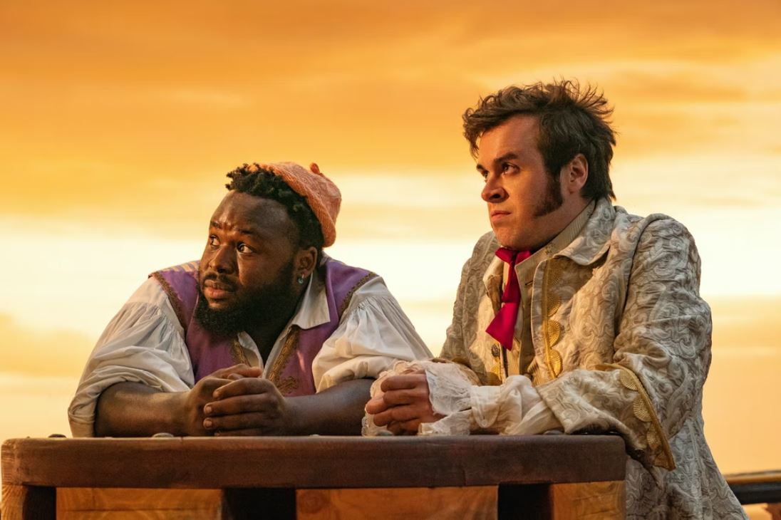 Oluwande played by Samson Kayo and Lucius played by Nathan Foad on Our Flag Means Death looking at a sun set. Image: HBO Max.