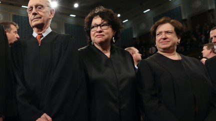 Supreme Court Justices Stephen Breyer, Sonia SOtomayor, and Elena Kagan stand in their robes