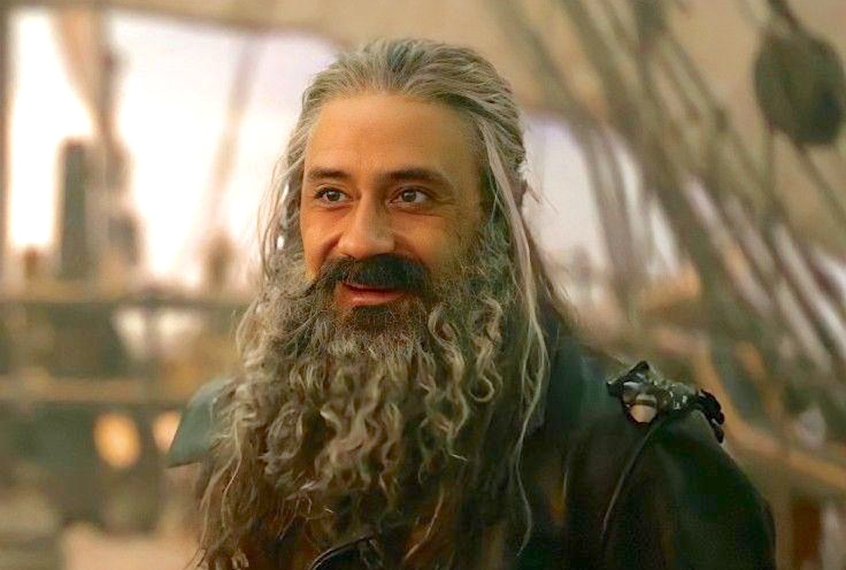 Taika Waititi smiles on deck of a ship as Blackbeard/Ed Teach in 'Our Flag Means Death'