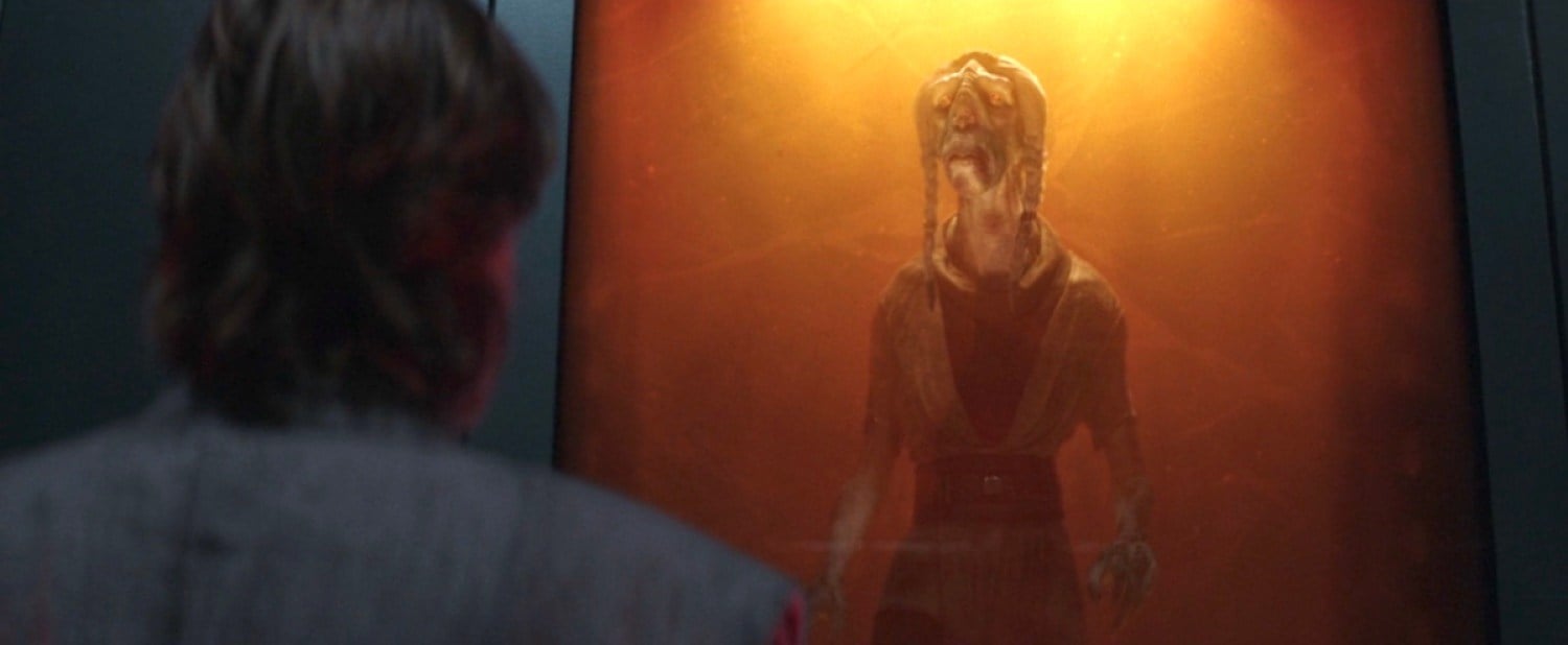 Obi-Wan looks at Tera Sinube, who is frozen in amber.