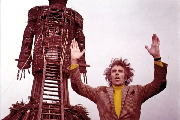 Lord Summerisle (Christopher Lee) stands in front of the wicker man.